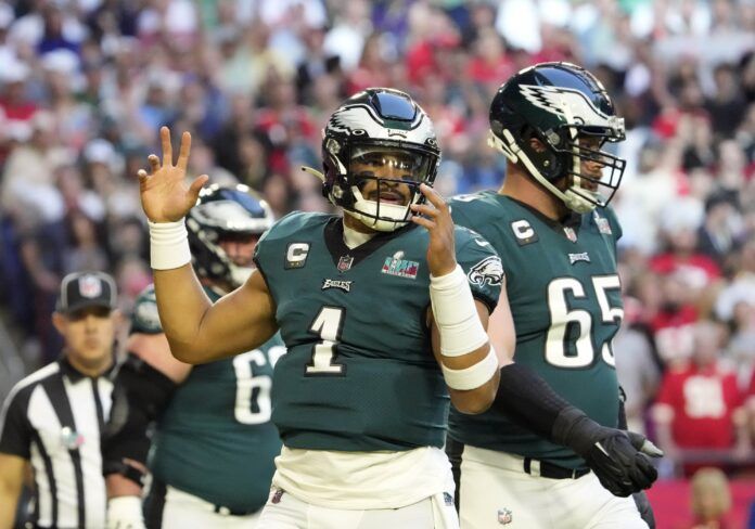 Philadelphia Eagles QB Jalen Hurts (1) celebrates alongside teammates after a touchdown.