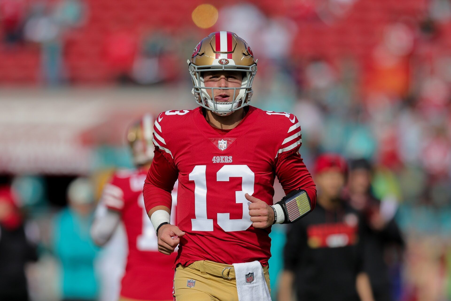 San Francisco 49ers QB Brock Purdy (13) runs onto the field against Miami.