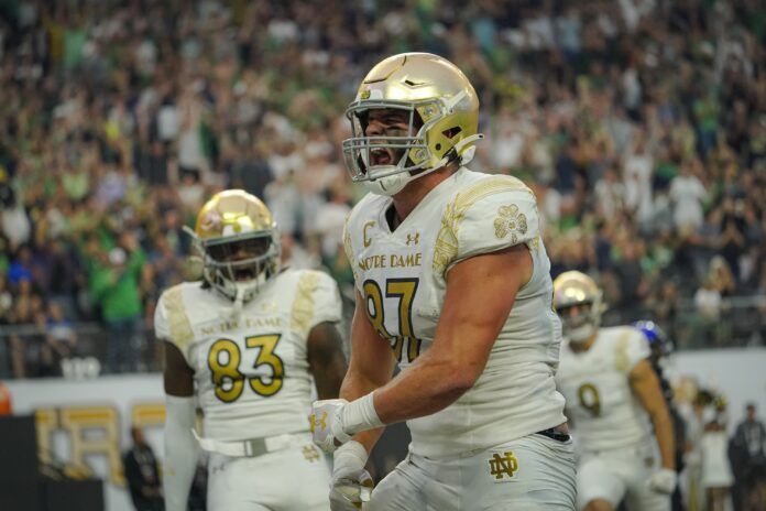 Notre Dame Fighting Irish tight end Michael Mayer (87) reacts after scoring a touchdown against the Brigham Young Cougars during the first half at Allegiant Stadium.