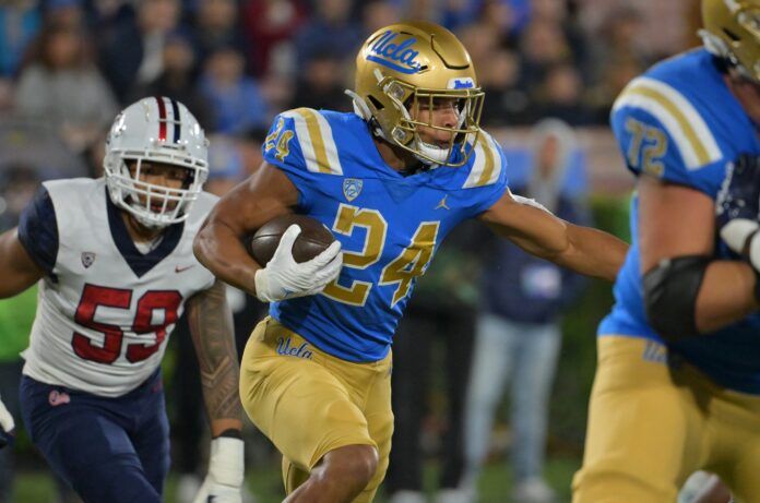 Running back Zach Charbonnet (24) runs the ball against Arizona.