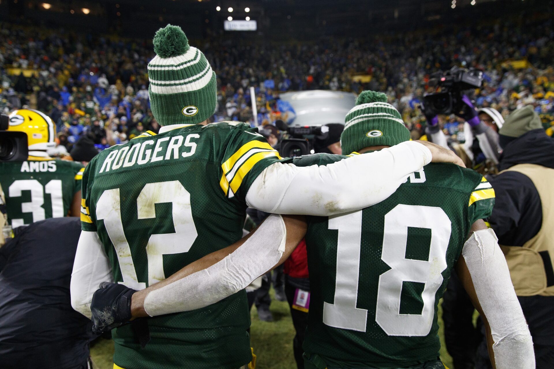 Quarterback Aaron Rodgers (12) and wide receiver Randall Cobb (18) walk off the field together.