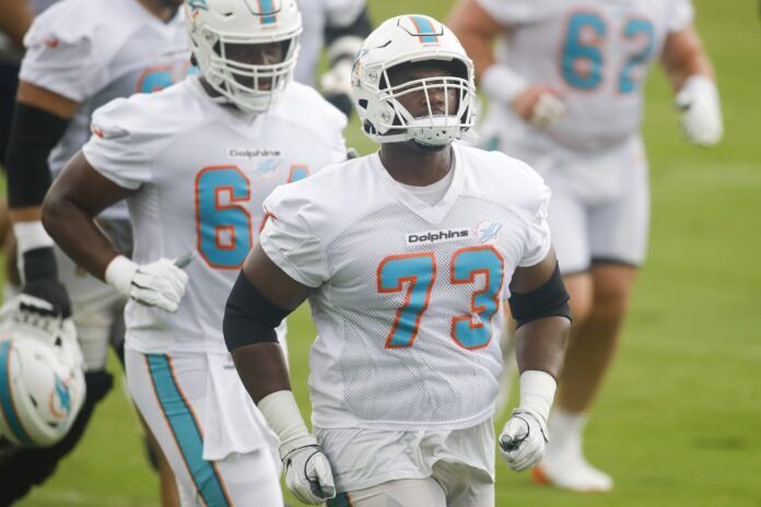 Miami OL Austin Jackson (73) runs on the field during minicamp practice.