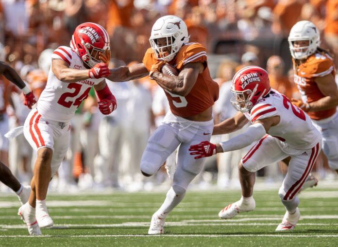 Texas RB Bijan Robinson (5) runs through Louisiana defenders.