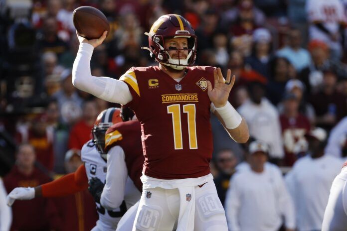 Quarterback Carson Wentz making a pass while a member of the Washington Commanders.