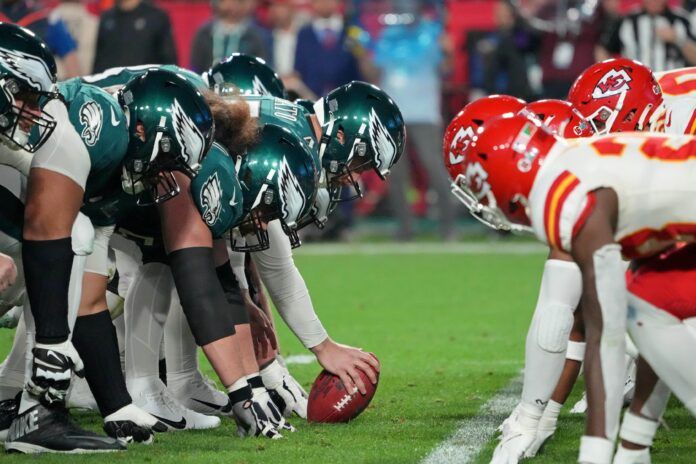 The Philadelphia Eagles and Kansas City Chiefs line up at the line of scrimmage during the third quarter of Super Bowl LVII at State Farm Stadium.