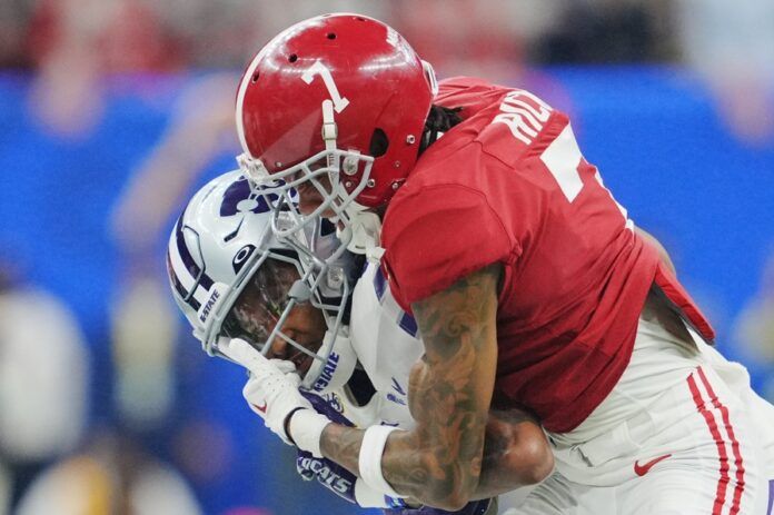 Alabama DB Eli Ricks (7) tackles Kansas State's Malik Knowles (4).