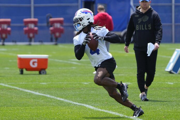 James Cook (4) runs with the ball after making a catch during Buffalo Bills Minicamp.