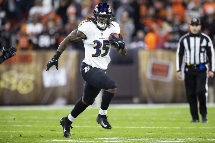 Gus Edwards (35) runs the ball against the Cleveland Browns during the second quarter at FirstEnergy Stadium.