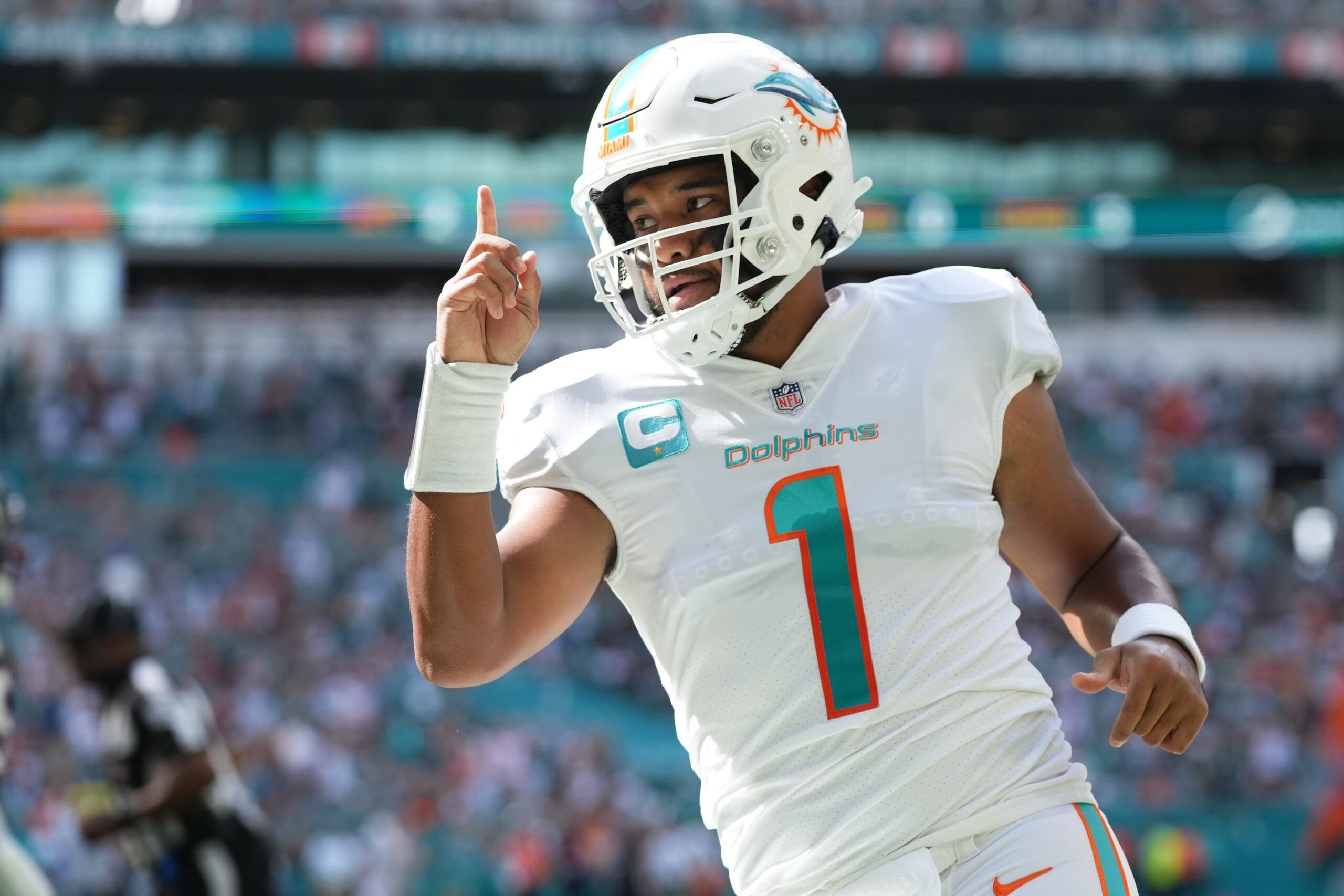 Tua Tagovailoa (1) celebrates his touchdown pass to tight end Durham Smythe (not pictured) during the first half against the Houston Texans at Hard Rock Stadium.