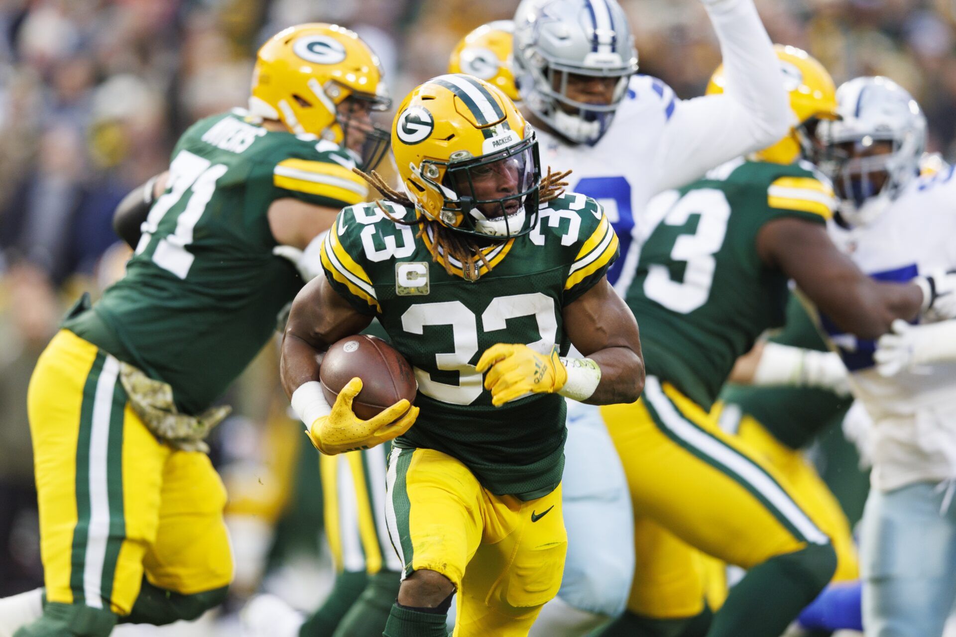 Aaron Jones (33) rushes with the football during the first quarter against the Dallas Cowboys at Lambeau Field.