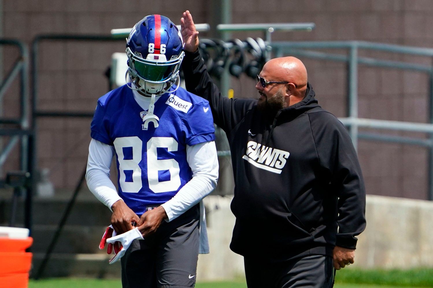 Brian Daboll, right, greets wide receiver Darius Slayton (86) on the first day of mandatory minicamp at the Giants training center in East Rutherford.