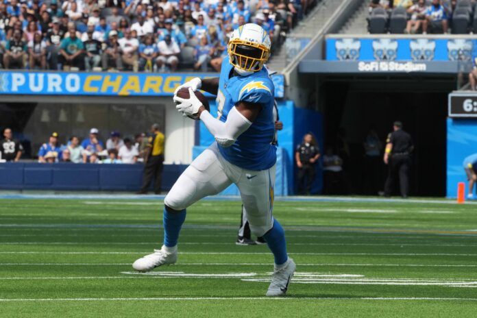 Gerald Everett (7) carries the ball against the Jacksonville Jaguars in the first half at SoFi Stadium.