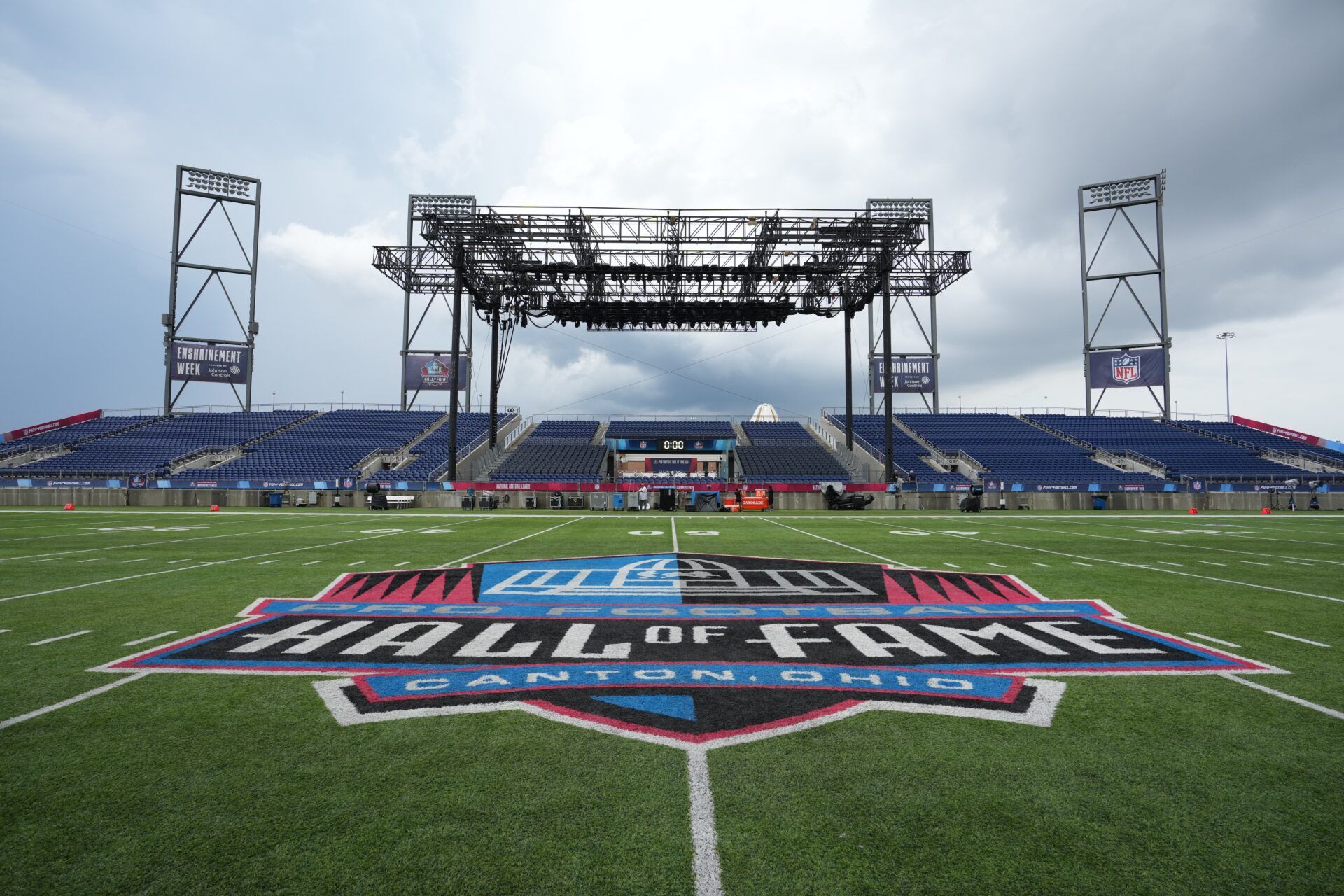 The Pro Football Hall of Fame logo at midfield at Tom Benson Hall of Fame Stadium.