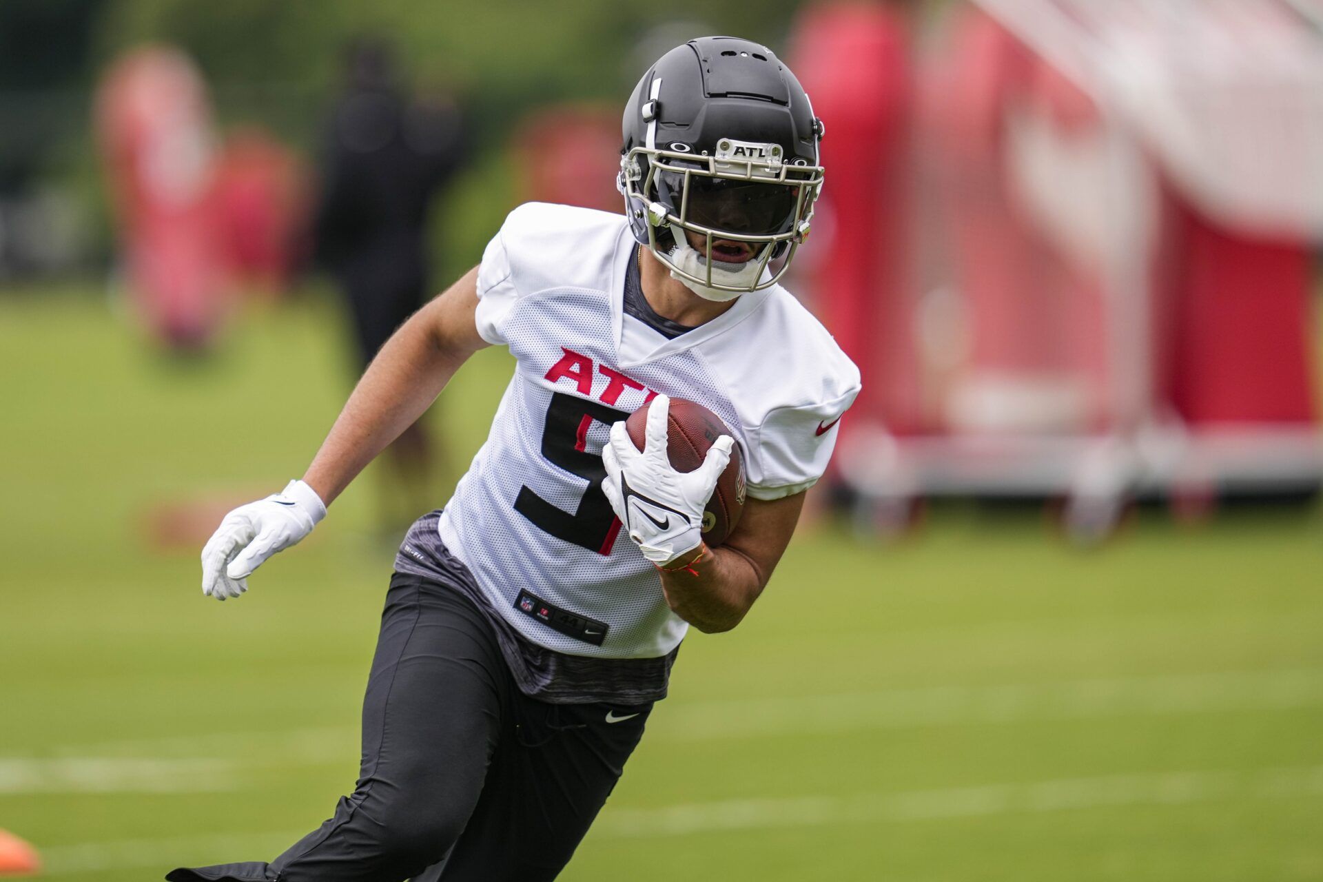 Drake London (5) runs after a catch during minicamp at IBM Performance Field.