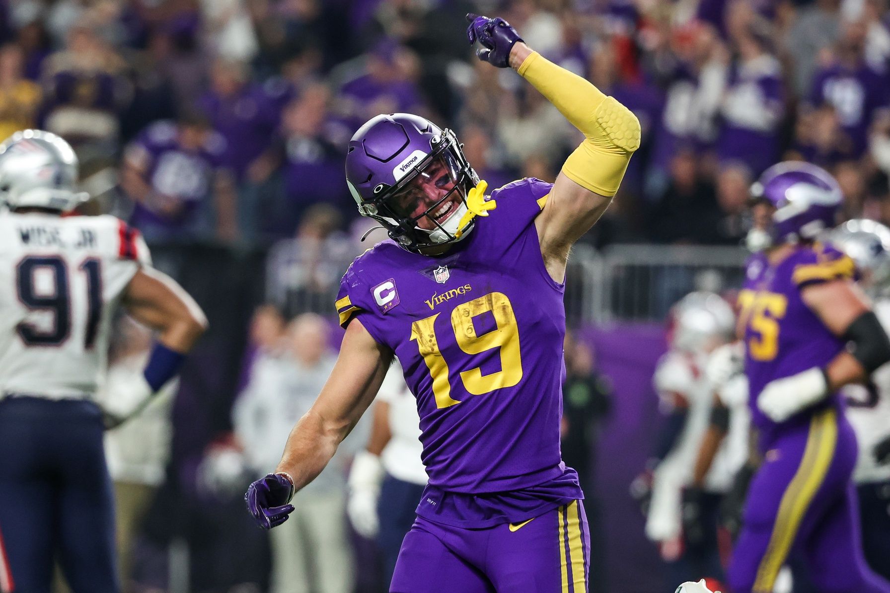 Adam Thielen (19) celebrates his touchdown against the New England Patriots during the fourth quarter at U.S. Bank Stadium.