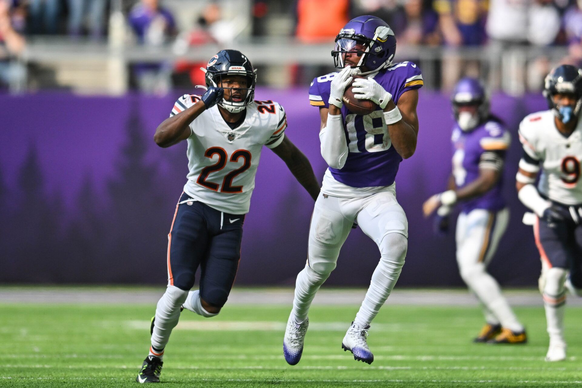 Justin Jefferson (18) and Chicago Bears cornerback Kindle Vildor (22) in action during the game at U.S. Bank Stadium.