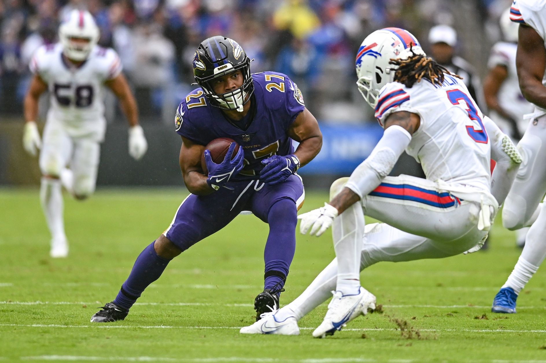 J.K. Dobbins (27) cuts in front of Buffalo Bills safety Damar Hamlin (3) during the second quarter.