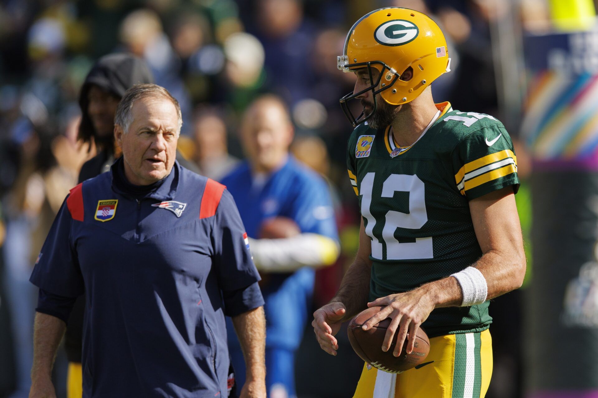 Green Bay Packers QB Aaron Rodgers (12) and New England Patriots head coach Bill Belichick chatting before the game.