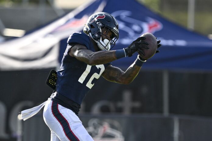 Houston Texans WR Nico Collins (12) catches a pass during the team's training camp.