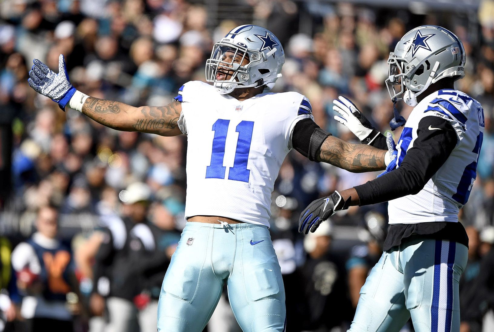 Micah Parsons (11) celebrates a sack during the first quarter against the Jacksonville Jaguars at TIAA Bank Field.