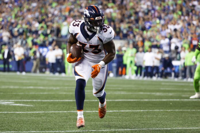 Javonte Williams (33) runs for yards after the catch against the Seattle Seahawks during the fourth quarter at Lumen Field.