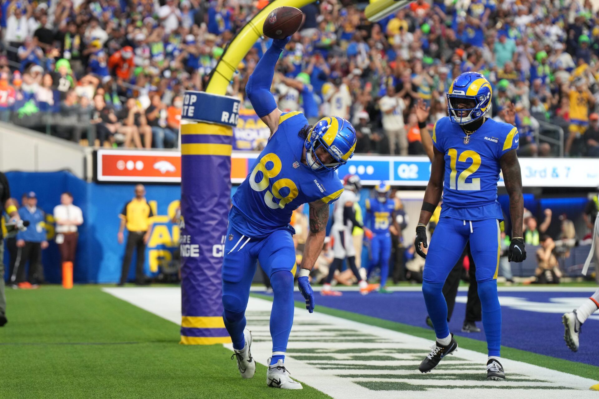 Tyler Higbee (89) celebrates with wide receiver Van Jefferson (12) after scoring on a 7-yard touchdown reception against the Denver Broncos in the first half at SoFi Stadium.