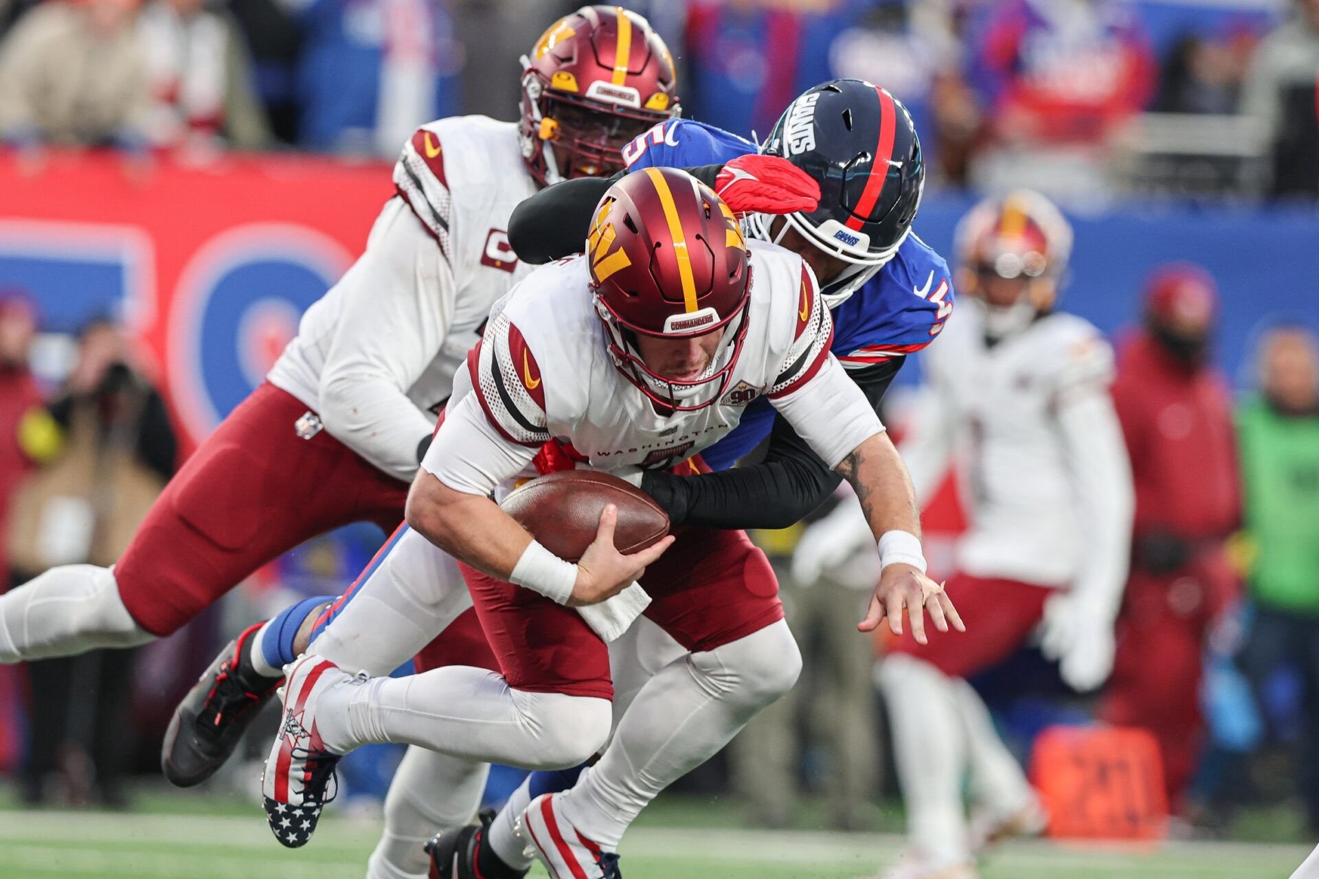 New York Giants defensive end Kayvon Thibodeaux (5) sacks Washington Commanders quarterback Taylor Heinicke (4).