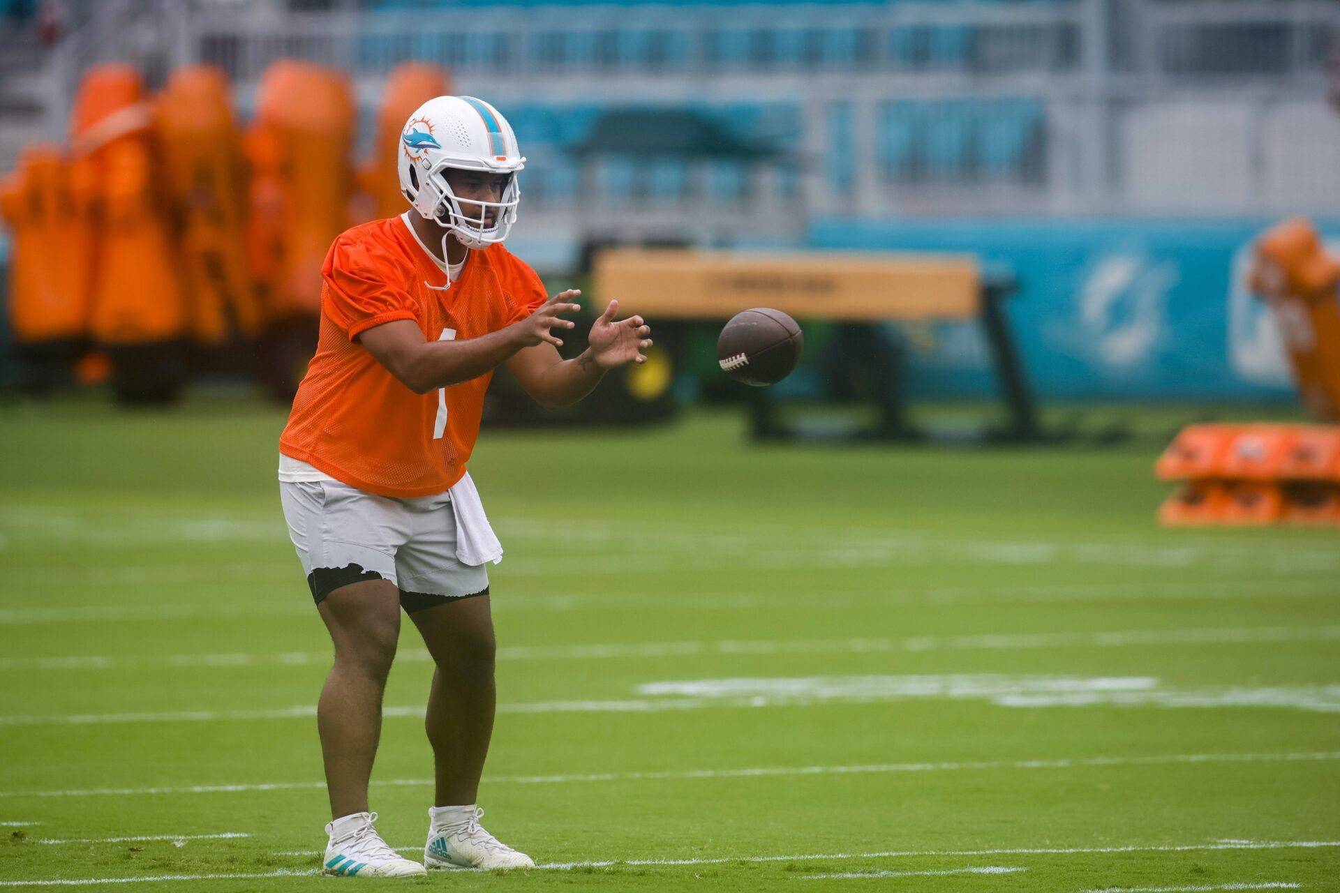 Miami Dolphins quarterback Tua Tagovailoa (1) catches the football during mandatory minicamp.