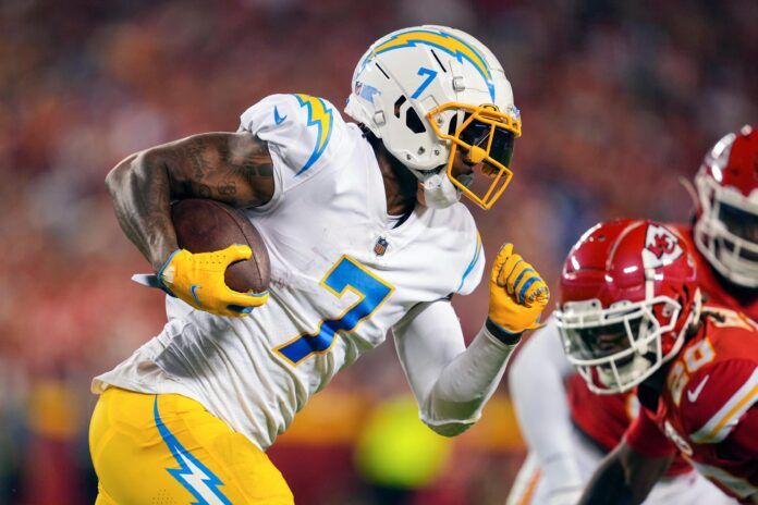 Gerald Everett (7) runs with the ball against Kansas City Chiefs safety Justin Reid (20) during the second half at GEHA Field at Arrowhead Stadium.