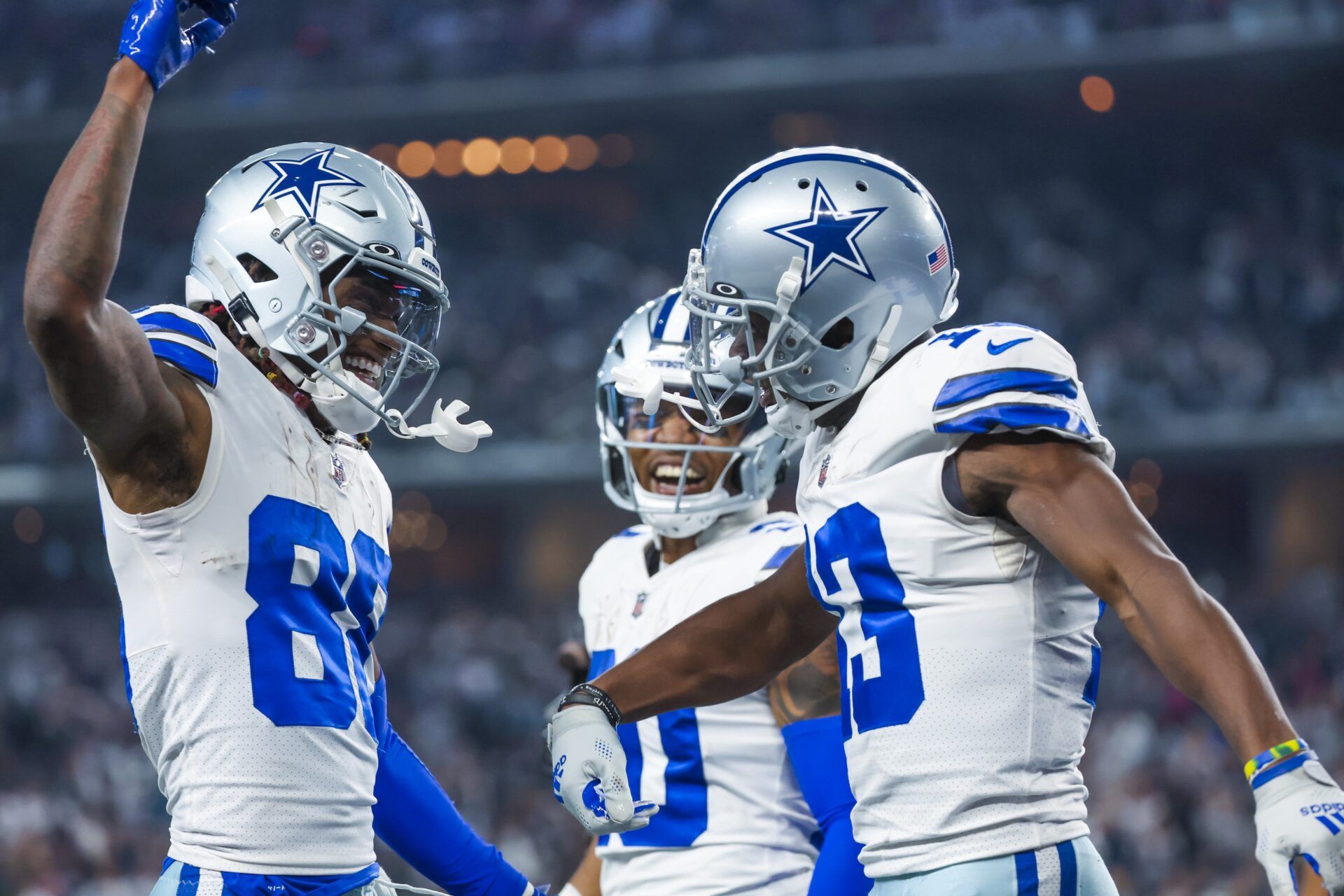 Dallas Cowboys WRs Michael Gallup (13) and CeeDee Lamb (88) celebrate with RB Tony Pollard (20).