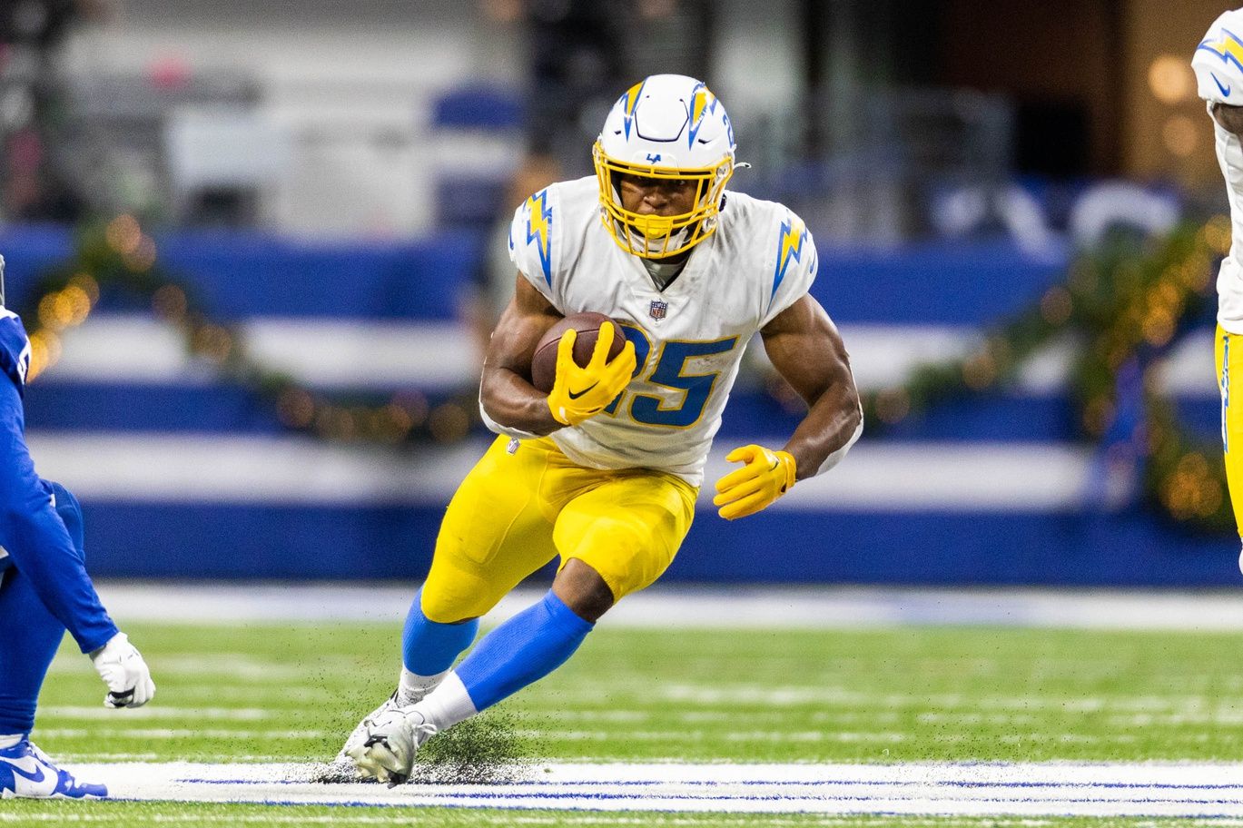 Joshua Kelley (25) runs the ball in the second half against the Indianapolis Colts at Lucas Oil Stadium.