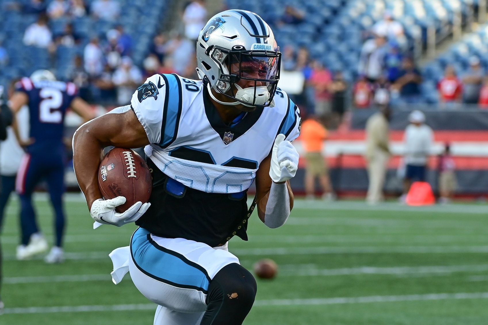 Chuba Hubbard (30) warms up before a preseason game against the New England Patriots at Gillette Stadium.