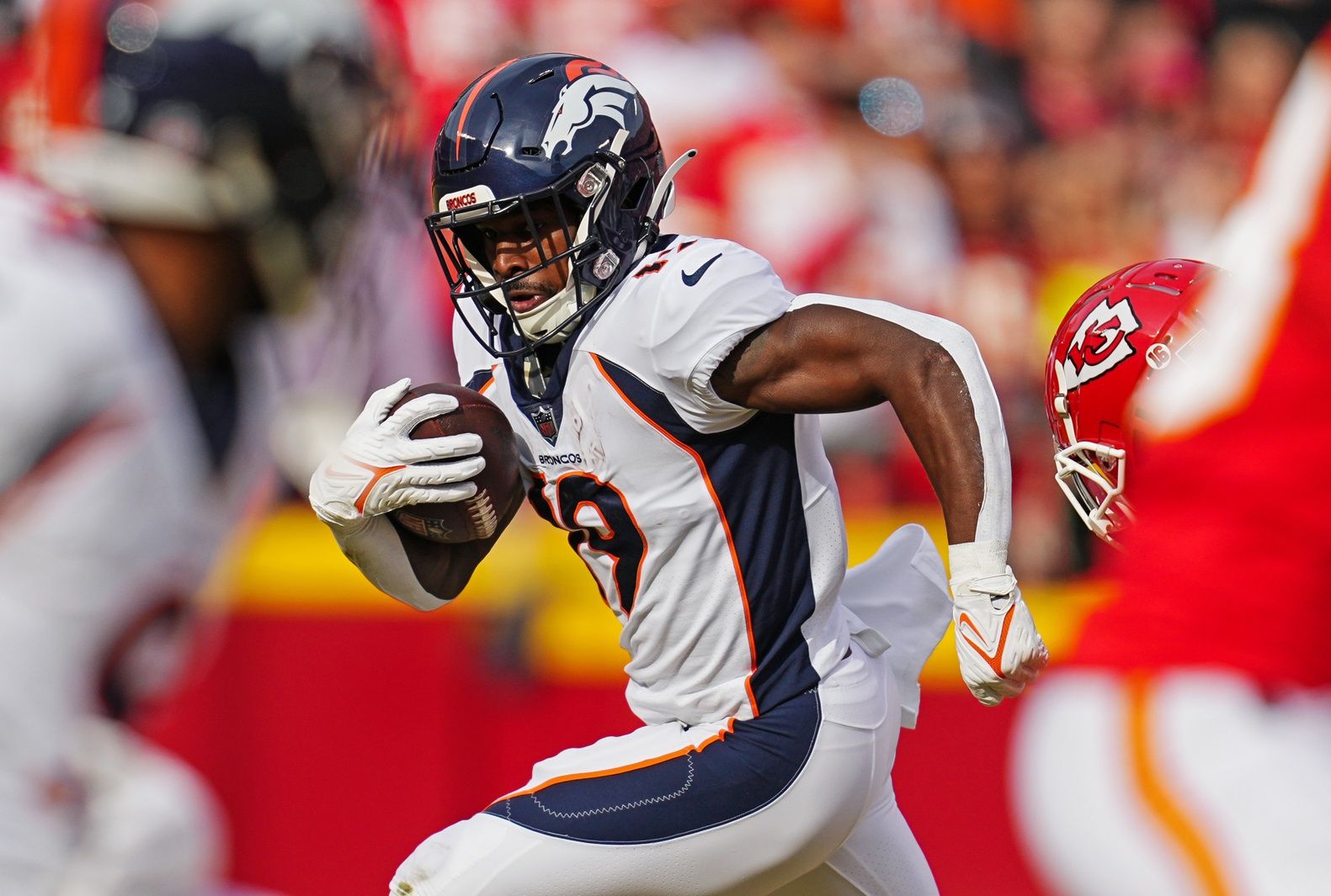 Chase Edmonds (19) runs the ball against Kansas City Chiefs safety Justin Reid (20) during the first half at GEHA Field at Arrowhead Stadium.
