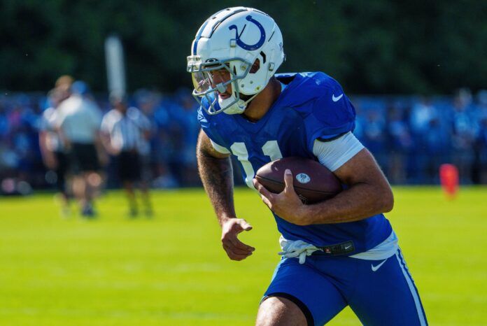 Michael Pittman Jr. (11) runs after catching a pass Monday, July 31, 2023, during training camp at the Grand Park Sports Campus.