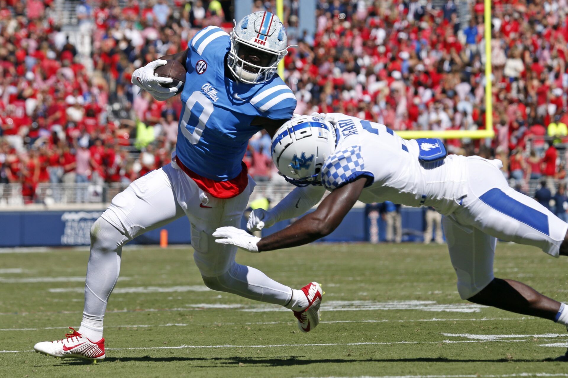 Ole Miss Rebels TE Michael Trigg (0) stiff-arms a Kentucky player.