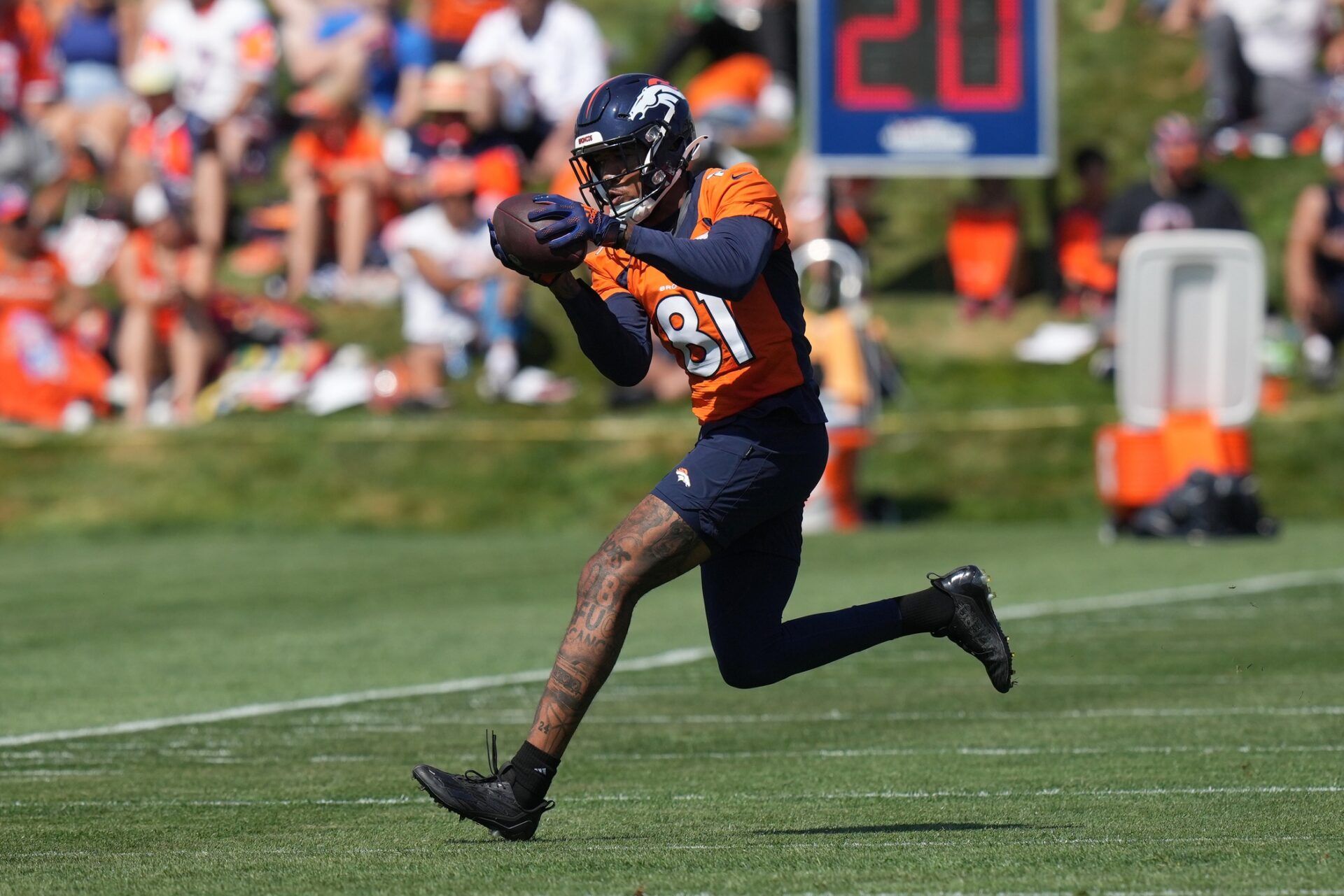 Tim Patrick (81) catches the ball during training camp at the UCHealth Training Center.