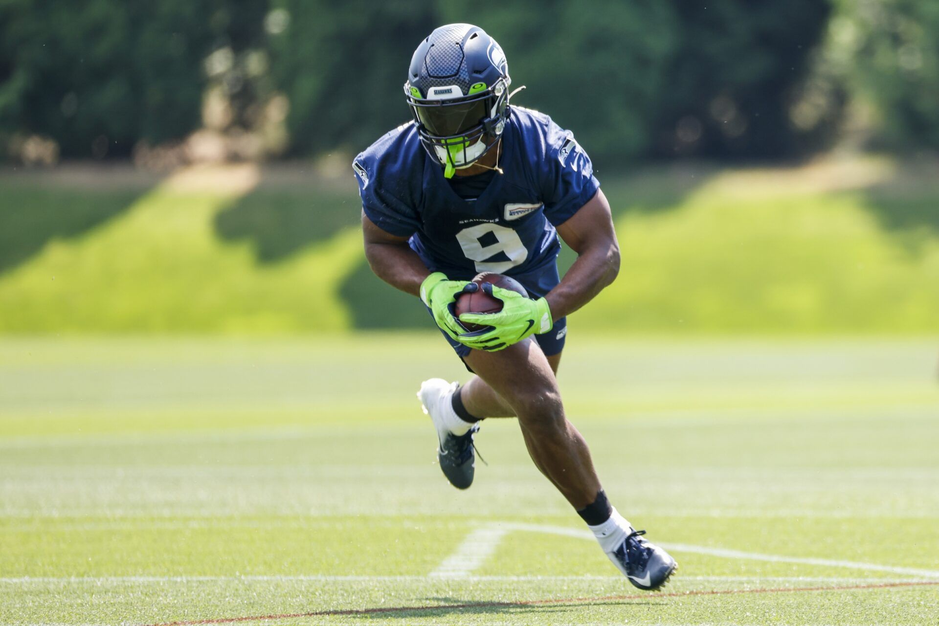 Seattle Seahawks RB Kenneth Walker III runs with the ball during training camp.