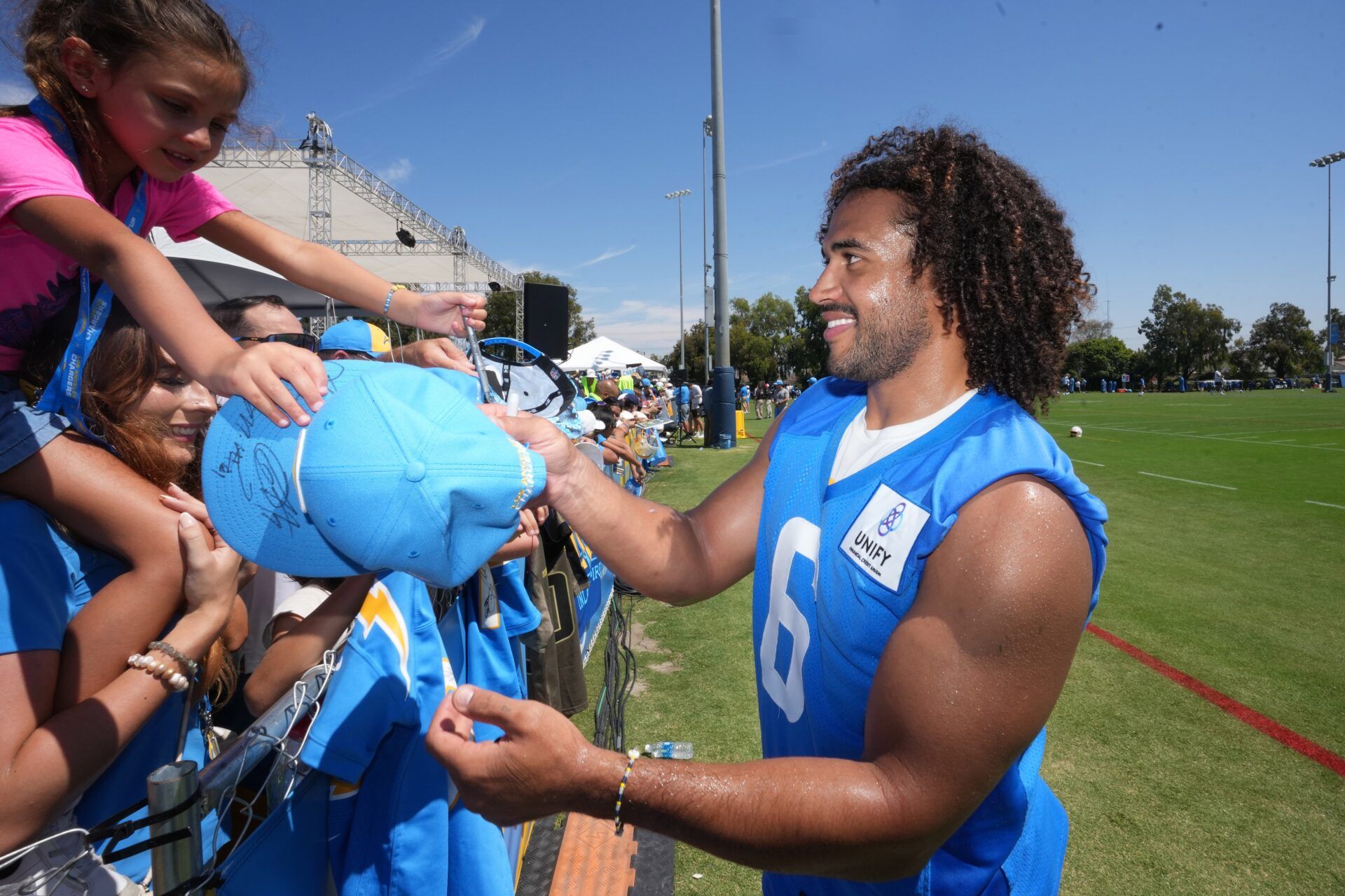 Los Angeles Chargers LB Eric Kendricks (6) signs autographs for friends.