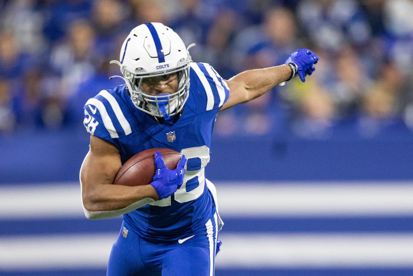 Jonathan Taylor (28) runs the ball in the first quarter against the New York Jets at Lucas Oil Stadium.