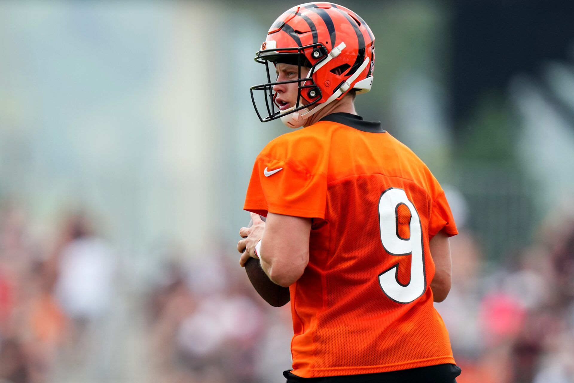 Joe Burrow (9) drops back to pass during training camp practice at the practice fields beside Paycor Stadium.