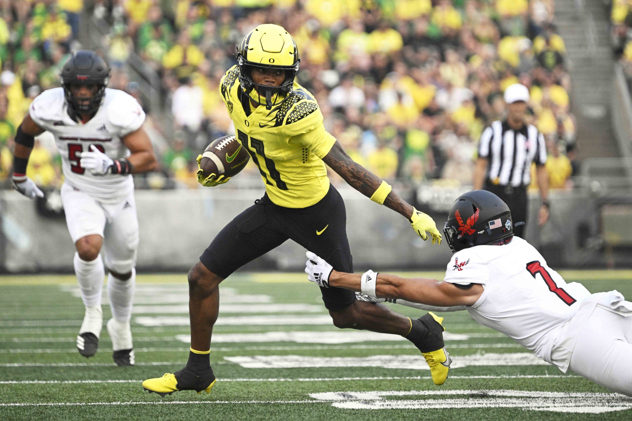 Troy Franklin (11) breaks away from Eastern Washington Eagles defensive back Tre Weed (7) during the first half at Autzen Stadium.