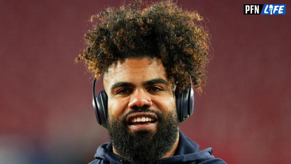 Ezekiel Elliott smiling at the camera after a game.