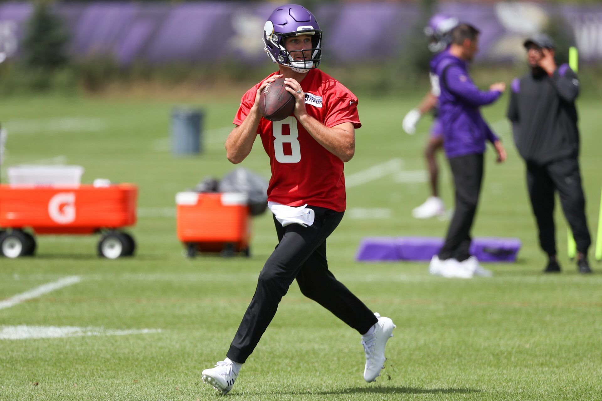 Kirk Cousins (8) performs a drill during training camp at TCO Performance Center.
