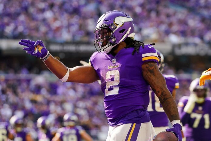 Alexander Mattison (2) celebrates a first down against the Chicago Bears in the fourth quarter at U.S. Bank Stadium.