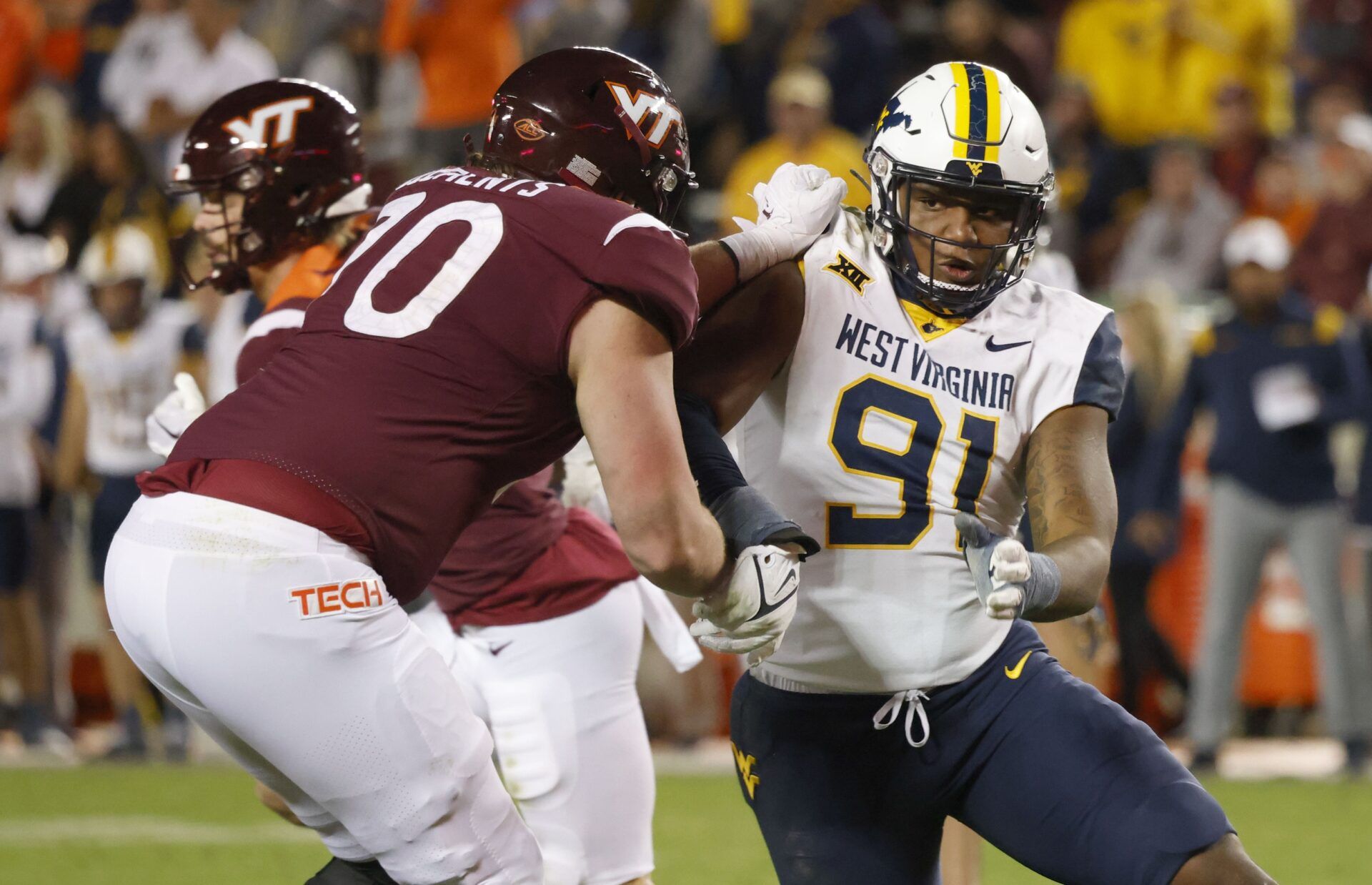 West Virginia DL Sean Martin (91) attempts to get past Virginia Tech Hokies OL Parker Clements (70).