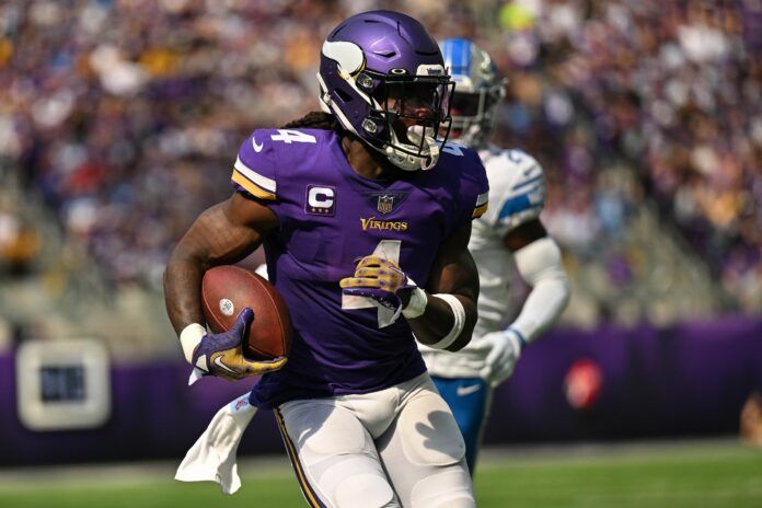 Dalvin Cook (4) and Detroit Lions cornerback Amani Oruwariye (24) in action at U.S. Bank Stadium.