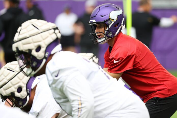 Kirk Cousins (8) performs a drill during training camp at US Bank Stadium.