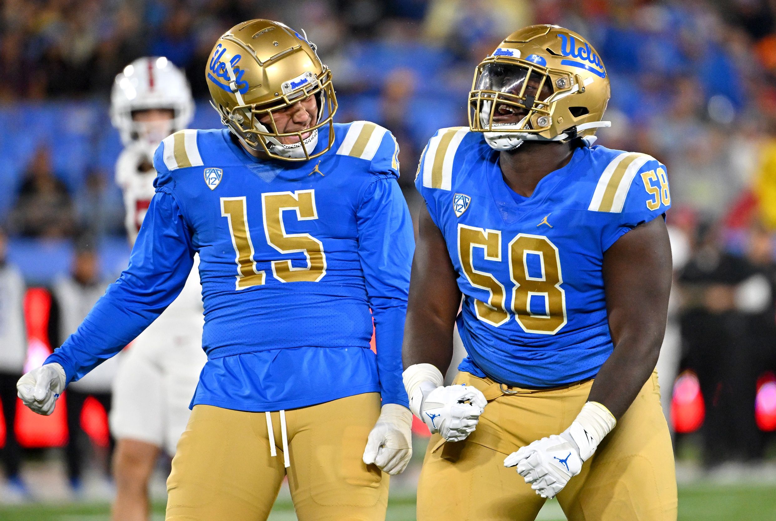 Laiatu Latu (15) and defensive lineman Gary Smith III (58) celebrate after a sack of Stanford Cardinal quarterback Tanner McKee (18) in the first half at the Rose Bowl.