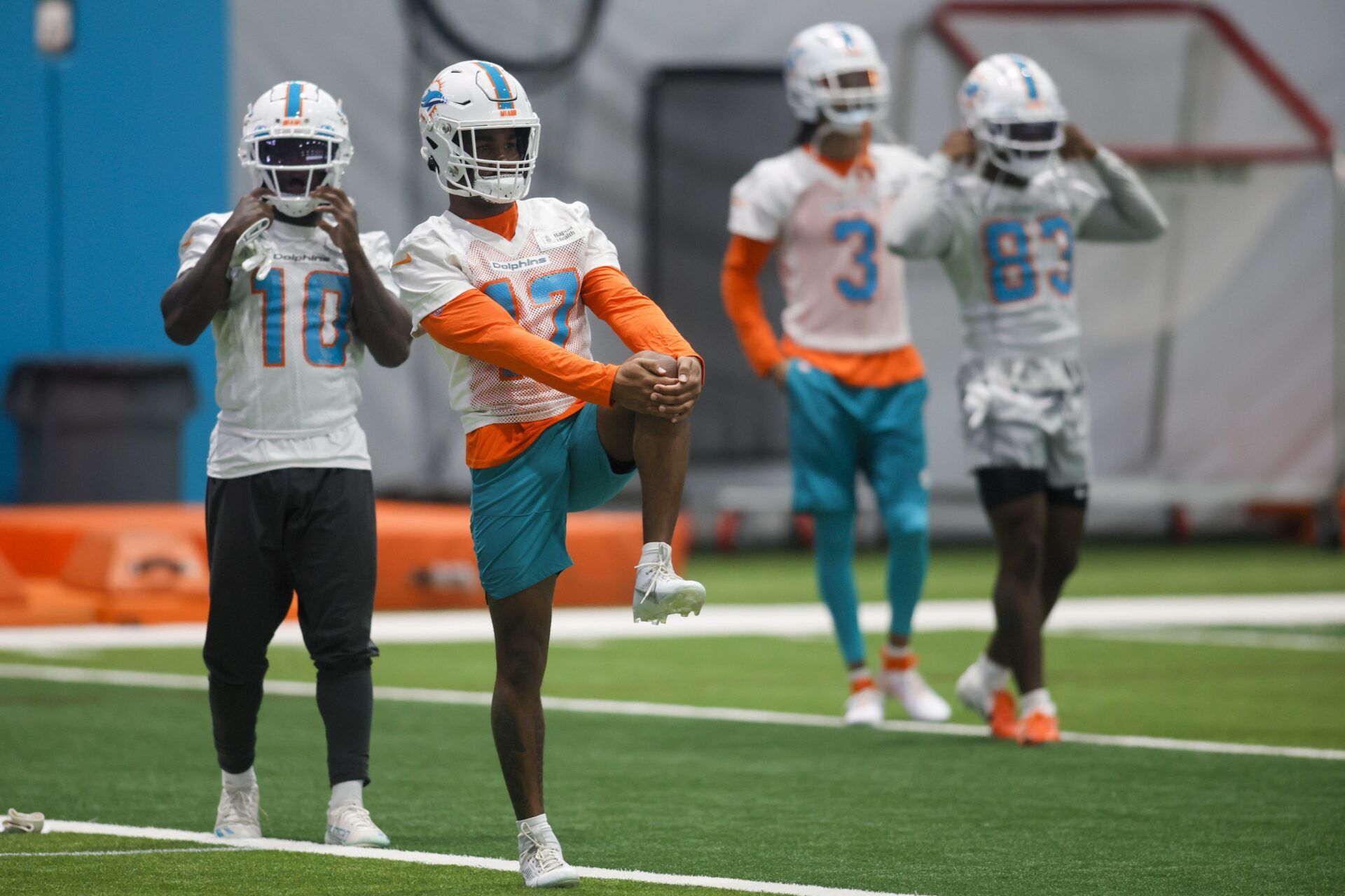Jaylen Waddle (17) stretches during mandatory minicamp at the Baptist Health Training Complex.