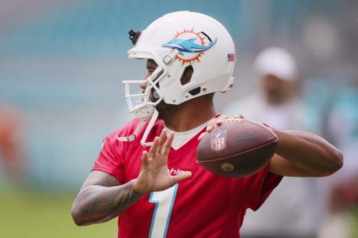 Miami Dolphins QB Tua Tagovailoa (1) throws passes during the team's training camp.